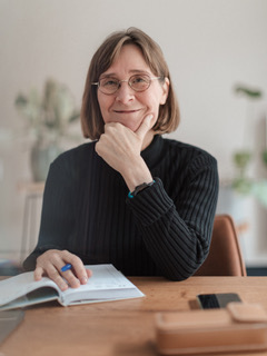 Smiling host at a desk
